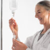 Healthcare professional preparing an IV drip for NAD therapy for longevity Mansfield TX