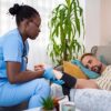 Concierge nurse monitoring blood pressure during post-surgical recovery at home visit