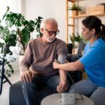 Chronic Illness Nursing Care: Nurse Checking Patient's Blood Pressure