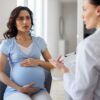 Pregnant woman discussing iron infusion during pregnancy with her provider during a consultation