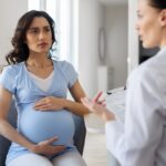 Pregnant woman discussing iron infusion during pregnancy with her provider during a consultation