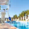 Mobile IV therapy for group events: an IV bag set up poolside at a resort-style outdoor gathering