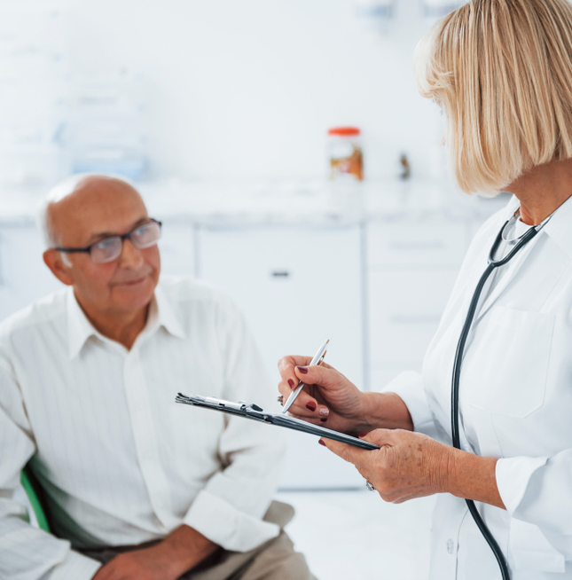 Healthcare provider reviewing medical information with an older adult patient